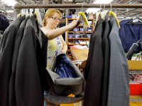 Carmen Martins measures custom suit jackets, at the Joseph Abboud manufacturing plant in New Bedford, MA.   [ PETER PEREIRA/THE STANDARD-TIMES/SCMG ]